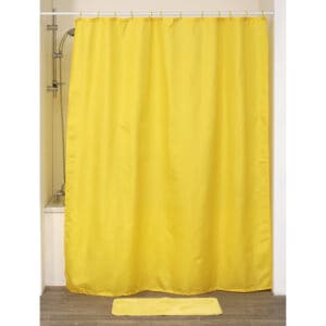 Yellow shower curtain displayed in bathtub setup with matching mat