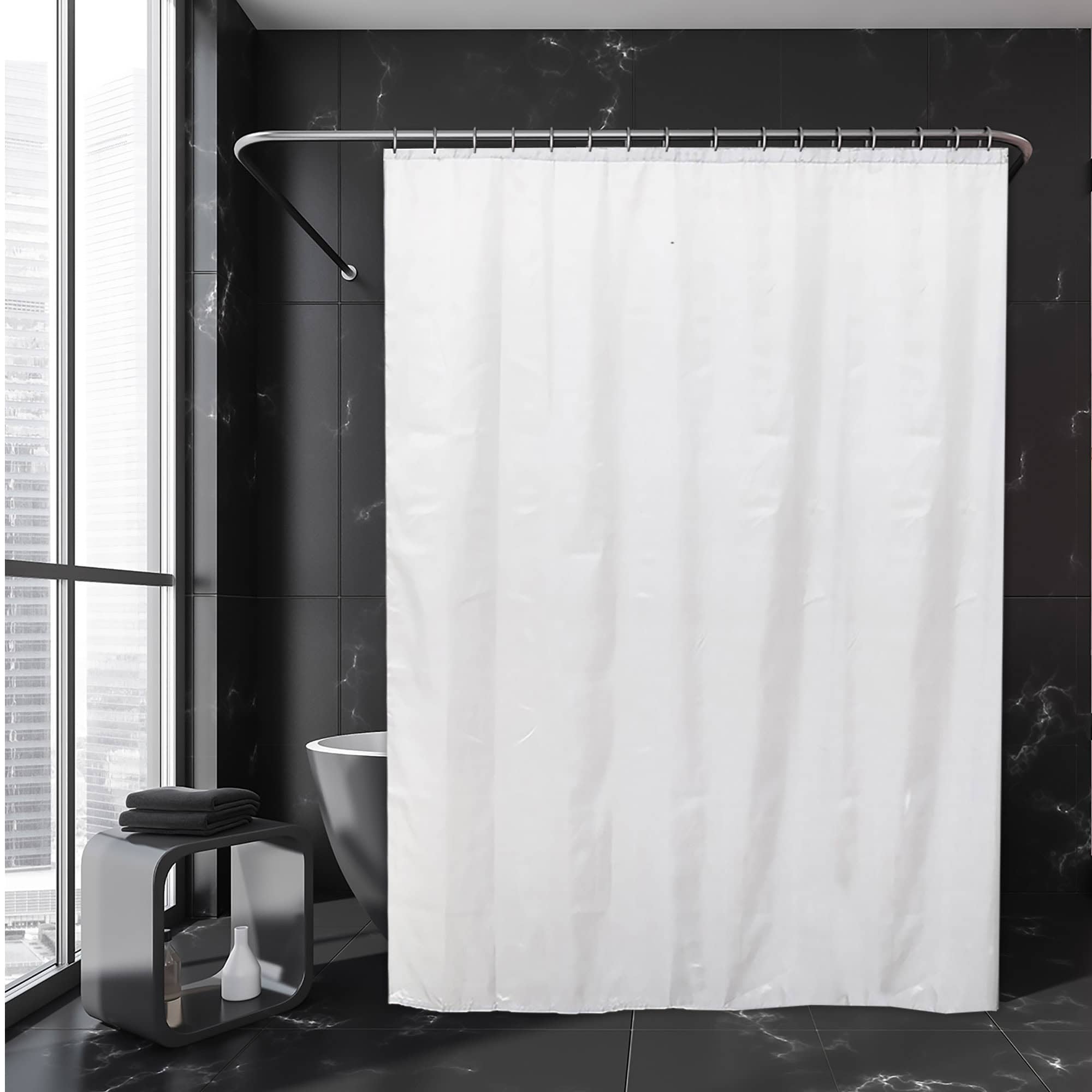 White extra-wide shower curtain hanging in modern black-tile bathroom