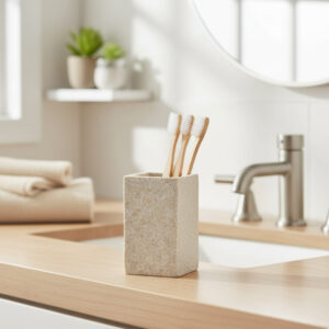 Natural stone effect tumbler toothbrush holder with bamboo brushes on sink