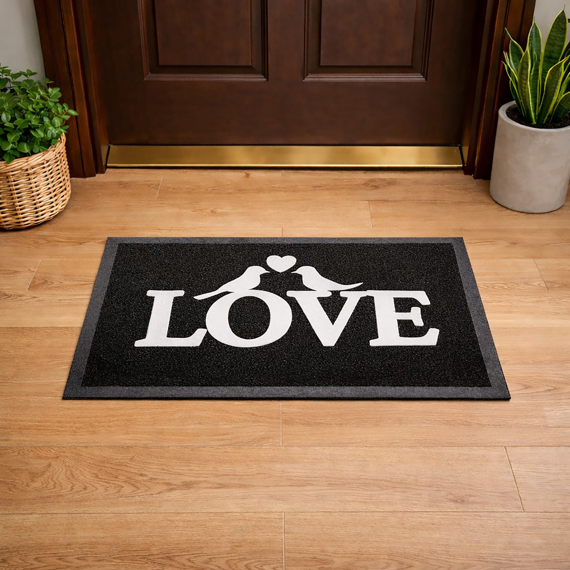 Lifestyle view of black LOVE door mat placed in front of wooden entry door