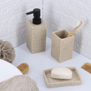 A natural stone-effect soap dispenser paired with a matching tumbler and tray, creating a cohesive bathroom accessory set.