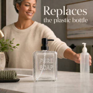 Woman replacing a plastic hand soap bottle with the clear glass Pure Soap dispenser on a vanity