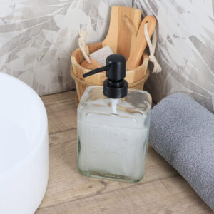 Stylish Glass Soap Dispenser for Bathroom Decor on Wooden Countertop – A clear glass soap dispenser with black pump sits elegantly on a wooden countertop, accompanied by bathroom essentials, adding a touch of style to the decor.