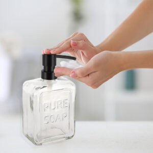 Hand Pump Operation on Clear Glass Soap Dispenser for Convenient Use – A person pressing the black pump of the clear glass soap dispenser, demonstrating the smooth and convenient hand-pump operation.