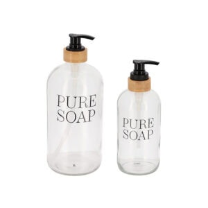 Two clear glass soap dispensers in large and medium sizes isolated on white background