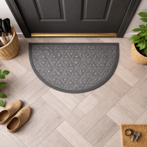 Top view of gray half round door mat in front of dark door