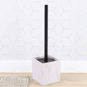 Stone effect toilet brush holder against white hexagonal tile wall