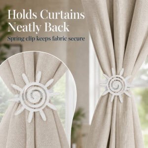 5- Distressed white sun tieback holding a flowing ivory curtain neatly to the side in a bright elegant room setting.