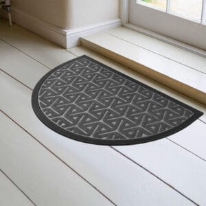 Gray half moon door mat placed inside entryway on light floor