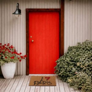 Paris doormat in front of red door outdoor entry