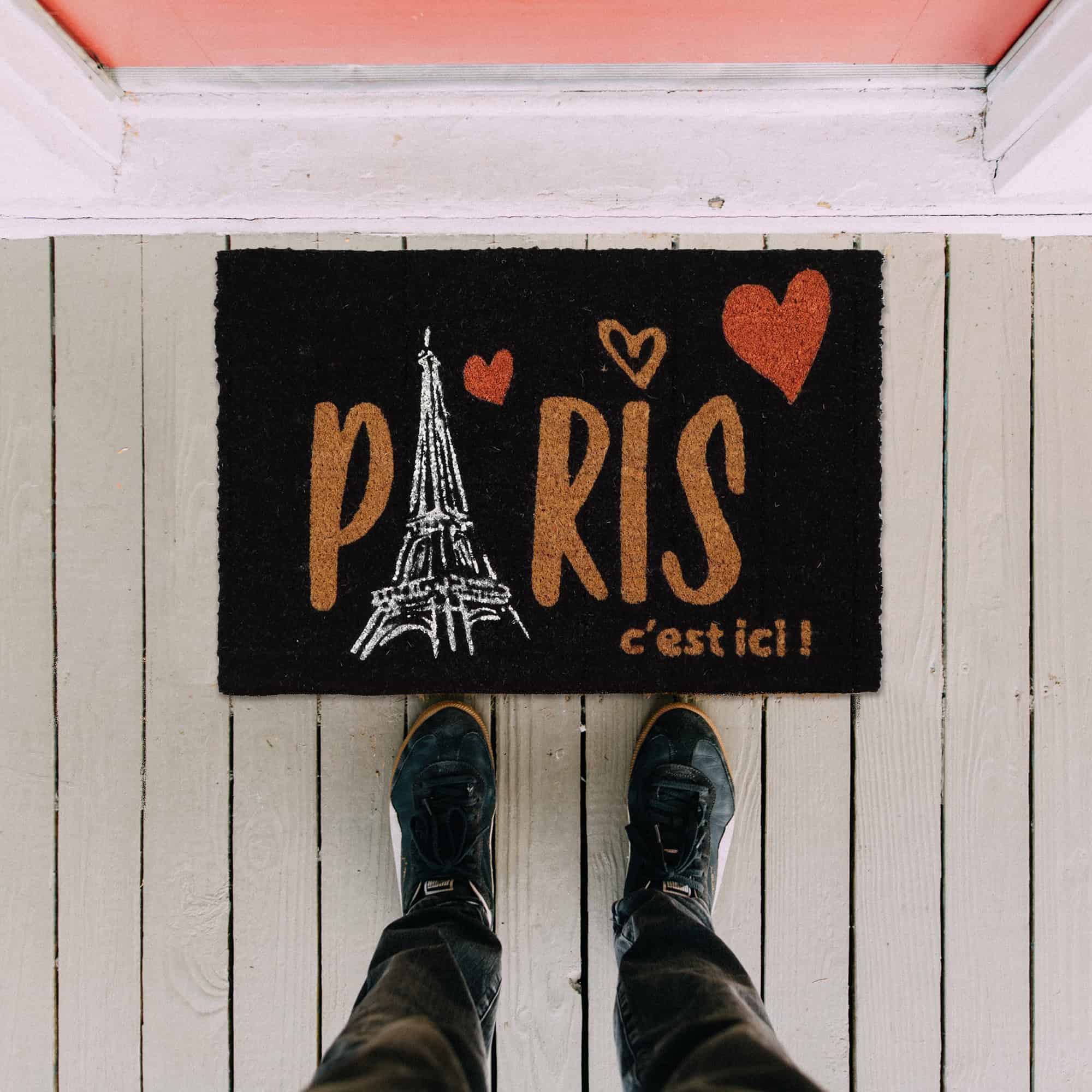 Paris door mat in situation on the floor with man legs and feet