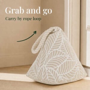 White leaf print cone door stopper against a door with an arrow pointing to its rope loop. On-image text: "Grab and go," "Carry by rope loop."