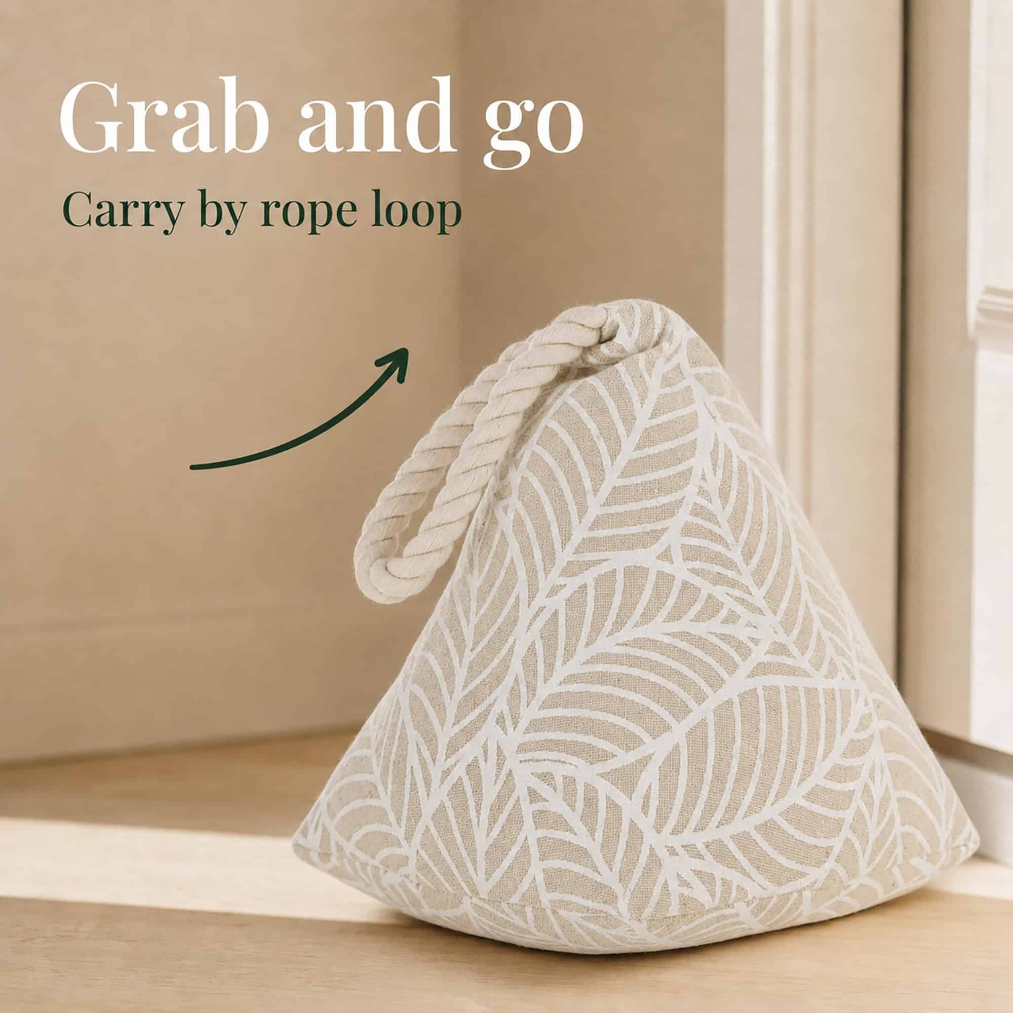 White leaf print cone door stopper against a door with an arrow pointing to its rope loop. On-image text: "Grab and go," "Carry by rope loop."
