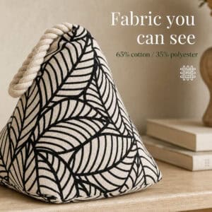 Black leaf print cone door stopper on a wood surface beside books, with a weave icon. On-image text: "Fabric you can see," "65% cotton / 35% polyester."