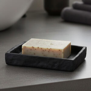 Black stone effect soap dish holding bar soap on bathroom countertop