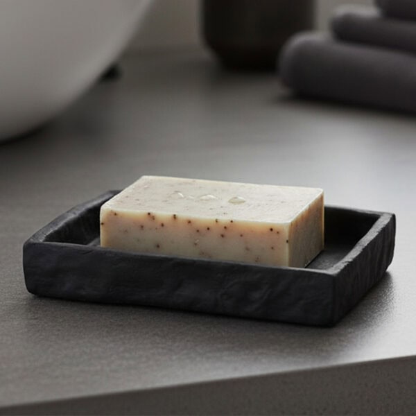Black stone effect soap dish holding bar soap on bathroom countertop