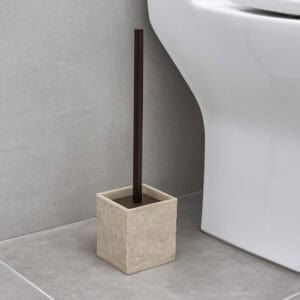 Natural stone effect toilet brush holder in beige next to white toilet