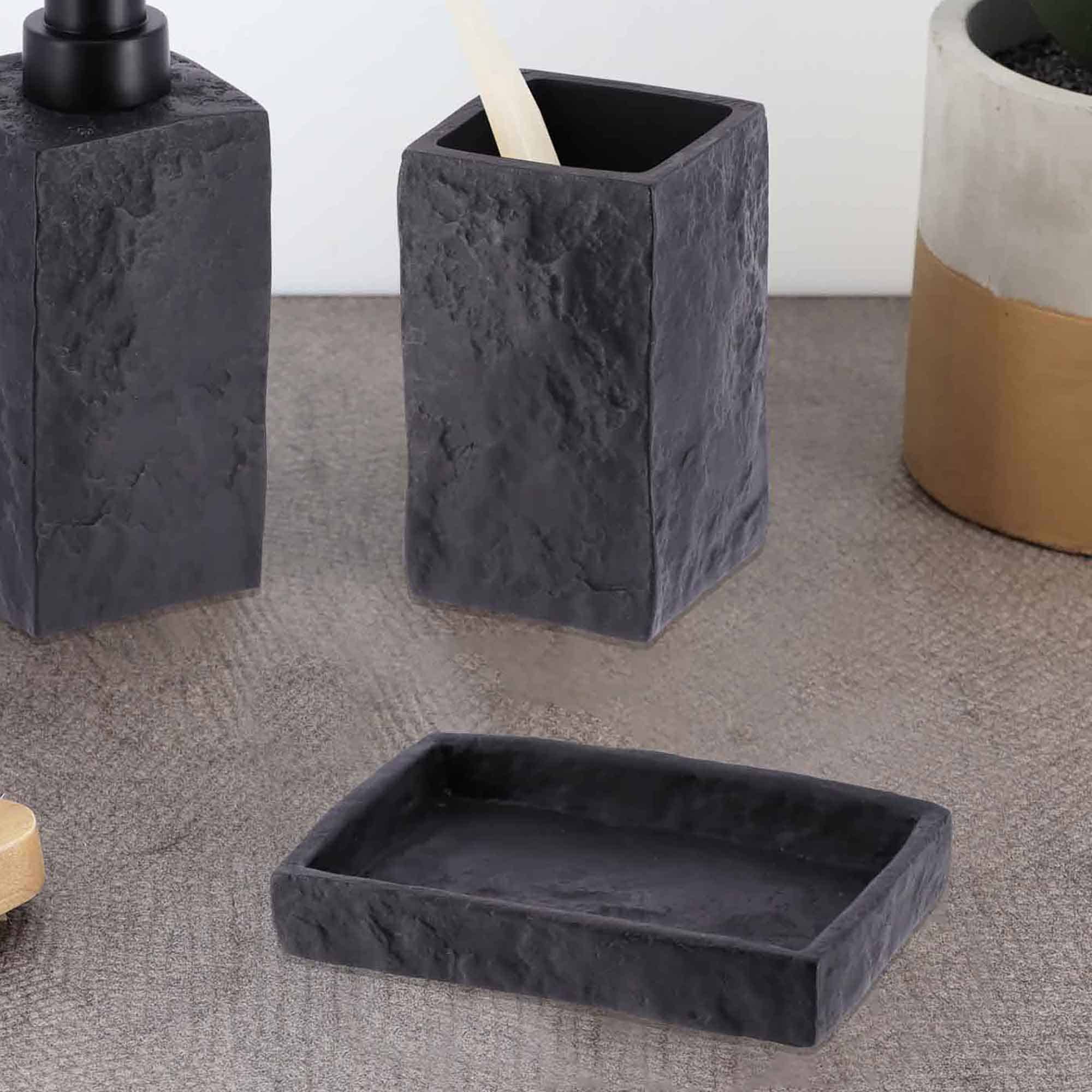 A close-up of a black stone-effect rectangular soap dish showcasing its minimalist design and smooth texture.