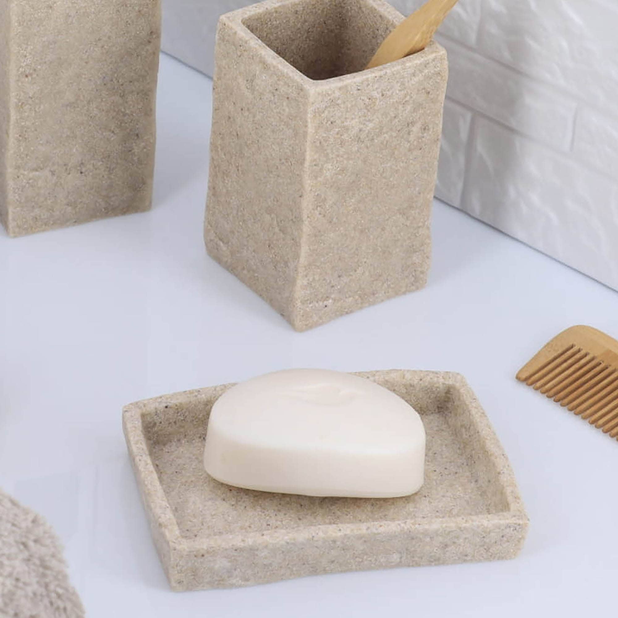 A close-up of a natural stone-effect rectangular soap dish showcasing its minimalist design and smooth texture.