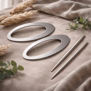 "Silver oval curtain tieback rings and pin rods displayed on taupe velvet fabric"