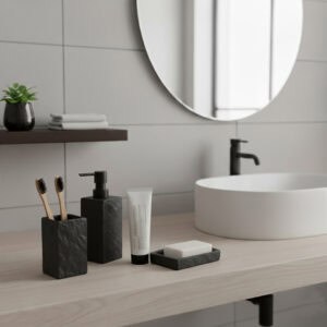 Black stone-effect bathroom accessory set with dispenser, tumbler, and soap dish on vanity