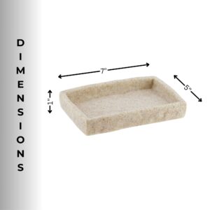 A natural stone-effect soap dish displayed alongside matching bathroom accessories, including a tumbler and a dispenser, on a countertop.
