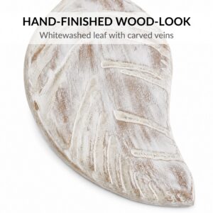 Close-up of whitewashed wood-look leaf tieback with carved veins and brushed finish