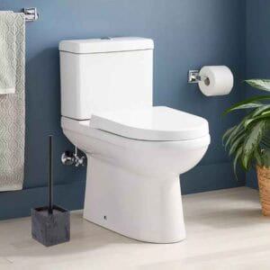 Black stone effect toilet brush holder beside white toilet in blue bathroom