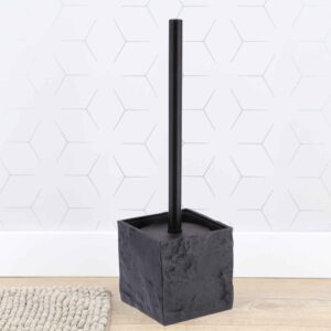 Black stone effect toilet brush holder against white hexagonal tile wall