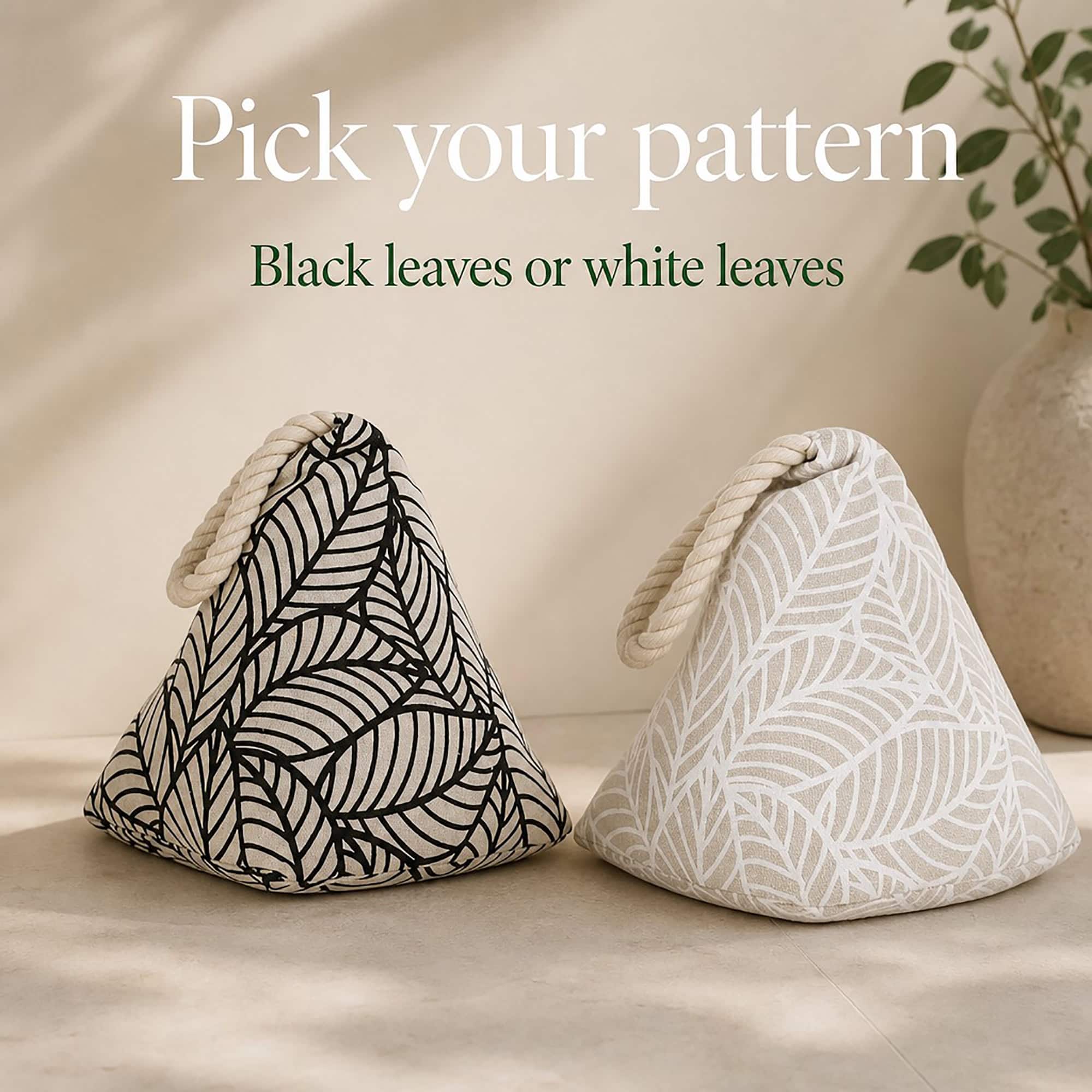 Two cone door stoppers side by side, one with a black leaf print and one with a white leaf print, both with cream rope loops. On-image text: "Pick your pattern," "Black leaves or white leaves."