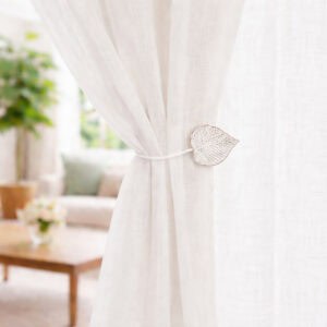 White leaf curtain tieback on sheer curtain, bright room