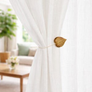 Natural wood leaf curtain tieback on sheer curtain, bright room