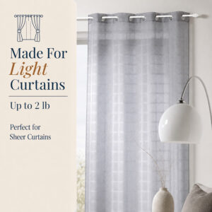 Grey sheer grommet curtain hanging from a white cafe rod in a bright living room