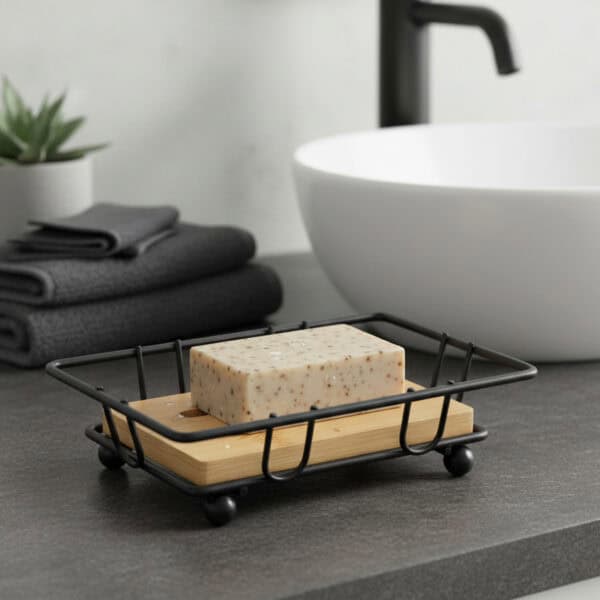 "Exfoliating soap bar on bamboo and black wire dish near bathtub"