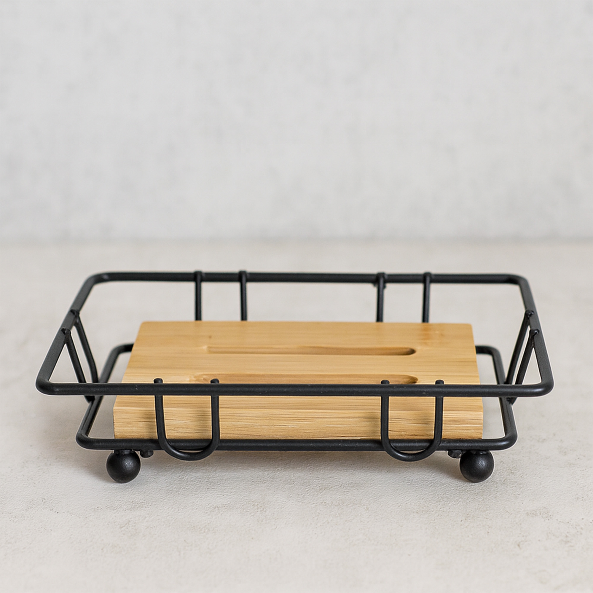 "Side view of empty black wire basket with bamboo soap tray"