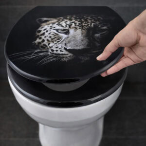 Close-up of black leopard print elongated toilet seat being lifted by hand