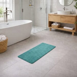 Peacock blue memory foam runner mat placed beside bathtub