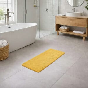Mustard yellow memory foam runner mat placed beside bathtub
