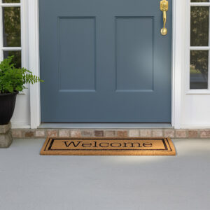 Welcome coir doormat placed at blue front door entrance