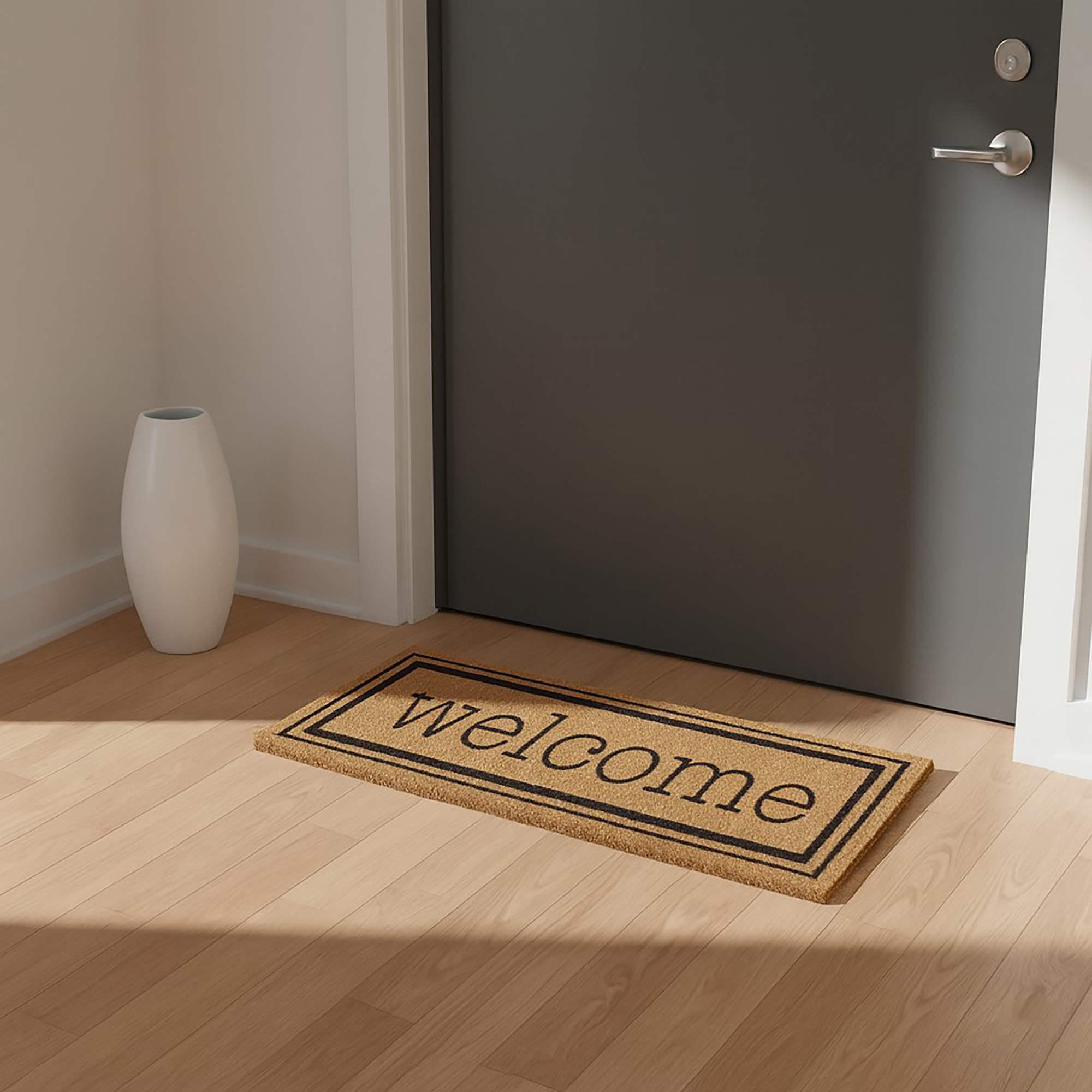 Welcome doormat indoors in front of gray apartment door