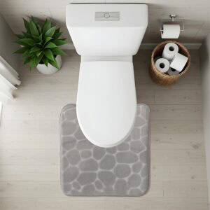 Top-down view of light gray pebble-texture contour mat fitted around toilet base