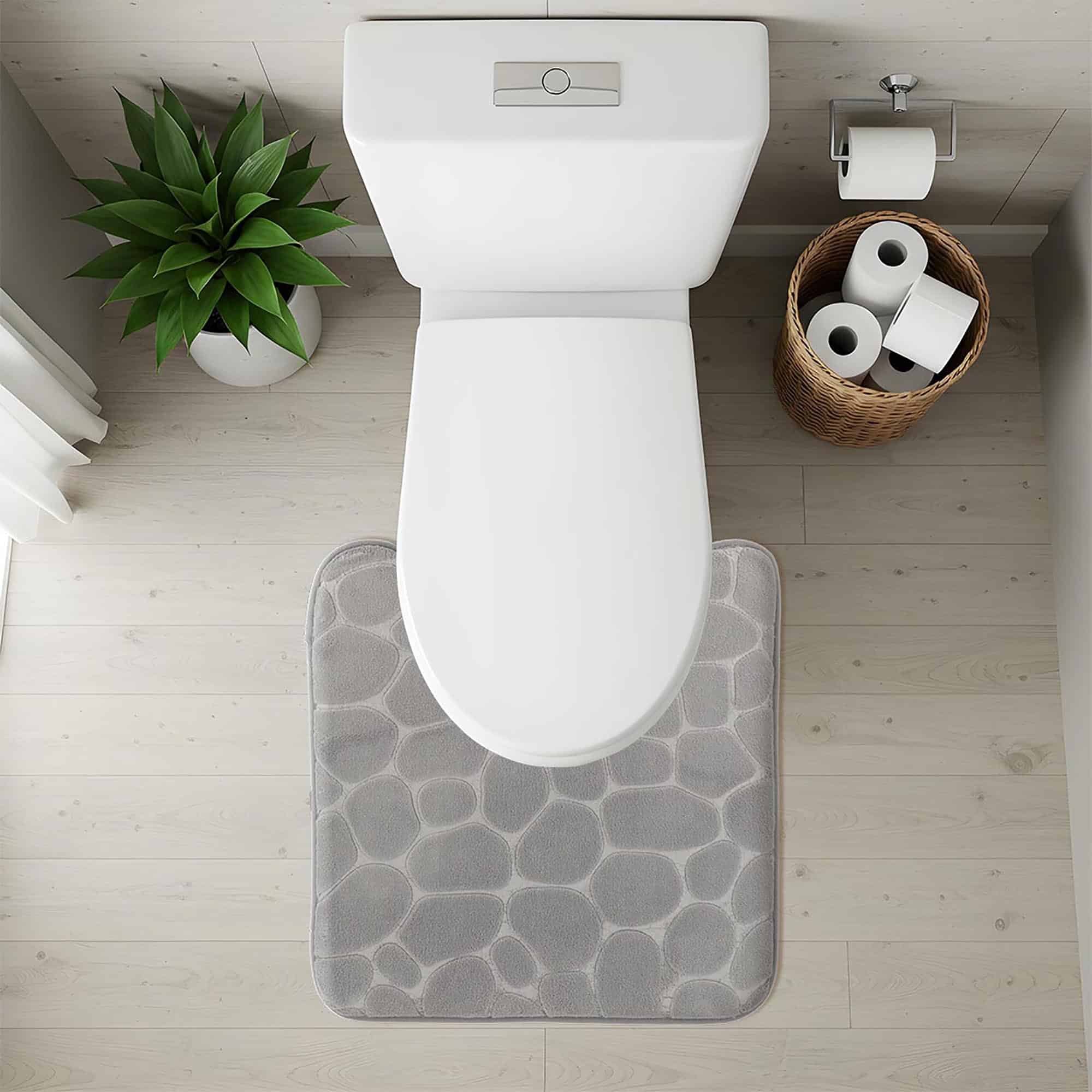 Top-down view of light gray pebble-texture contour mat fitted around toilet base