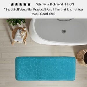 Peacock blue memory foam runner mat placed beside bathtub in spa-style bathroom with customer review highlighting versatility and size