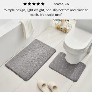 Light gray contour and standard memory foam mats with pebble design positioned around toilet with slippers and customer review overlay