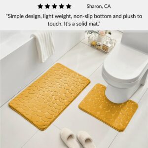 Mustard yellow contour and standard memory foam mats with pebble design positioned around toilet with slippers and customer review overlay