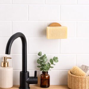 "Wall-mounted bamboo soap holder with bar soap in modern bathroom setting"