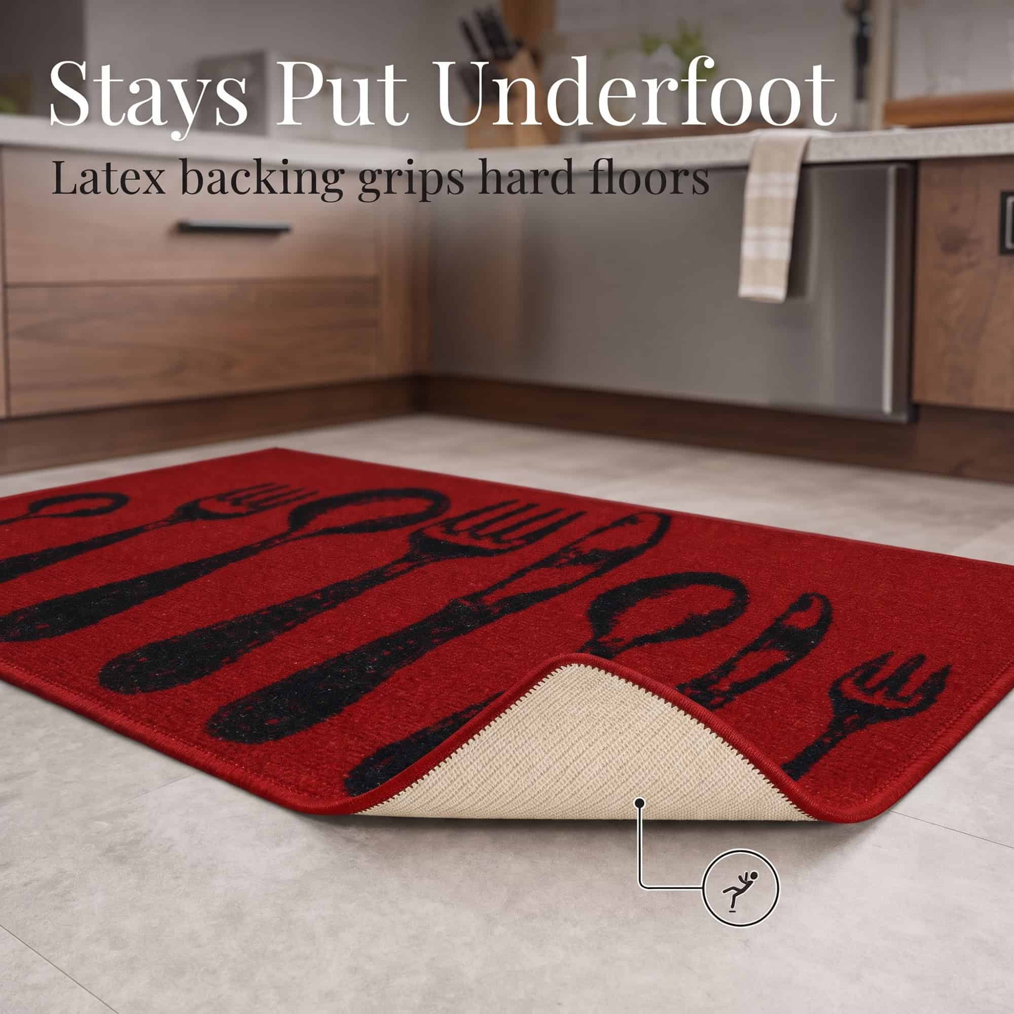 Corner of the red non slip kitchen mat folded back to reveal the tan latex backing that grips hard floors and helps prevent slipping.