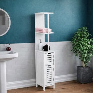 "Tall white bathroom cabinet with two open shelves and two louvered drawers, styled in a teal bathroom"