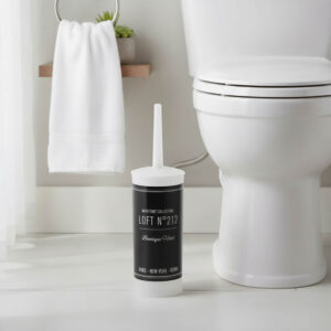 "Loft No. 212 decorative toilet brush beside white toilet in bathroom"