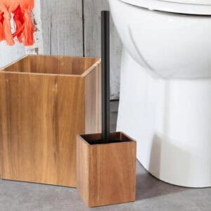 A matching set featuring a wooden waste basket and a toilet brush holder with a black handle, placed near a toilet.